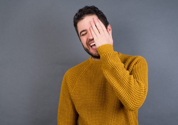 Man laughing at Shavuos jokes